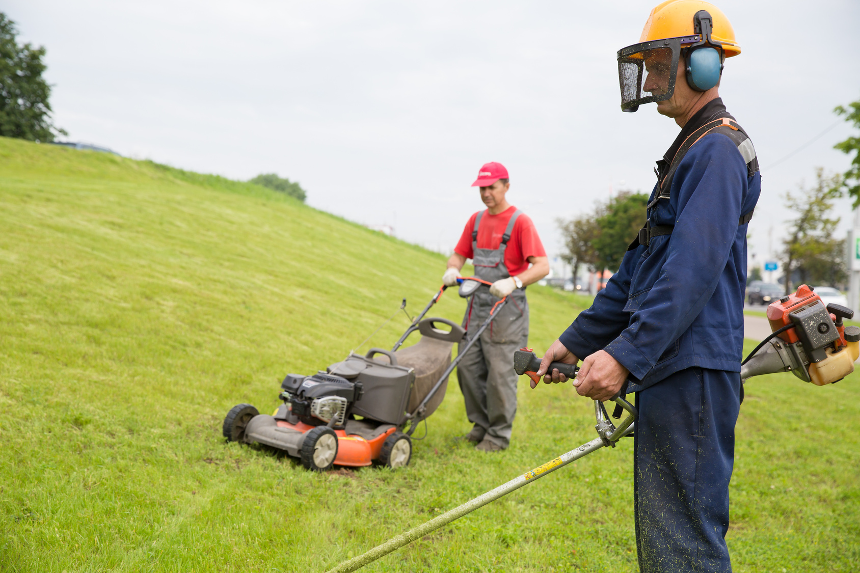 men mowing lawn